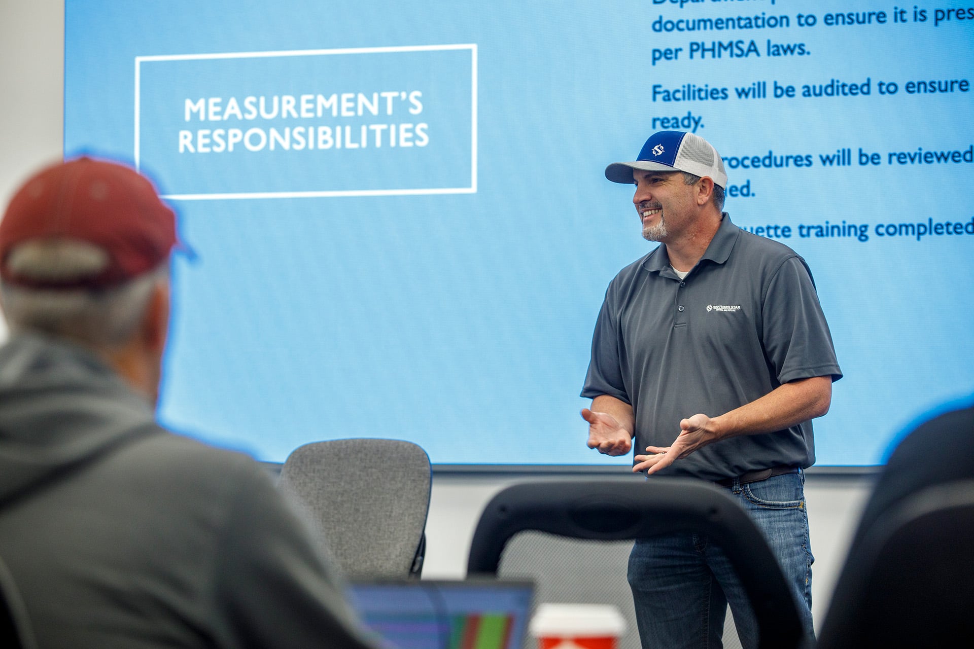 A Male Southern Star Employee speaking in front of a screen